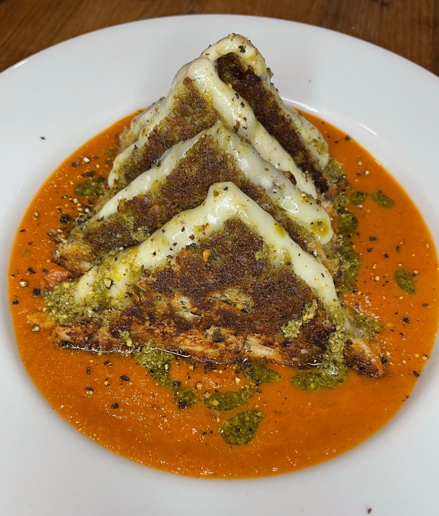 Cheese toastie on a plate of soup